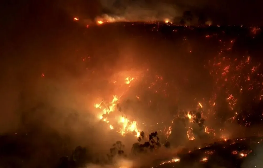 Evacuations and shelters set as fire spreads in Hollywood Hills