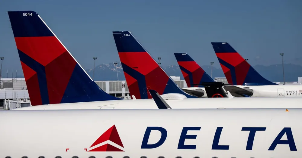 Japan Airlines Flight Clips Tail of Parked Delta Aircraft at Seattle Airport