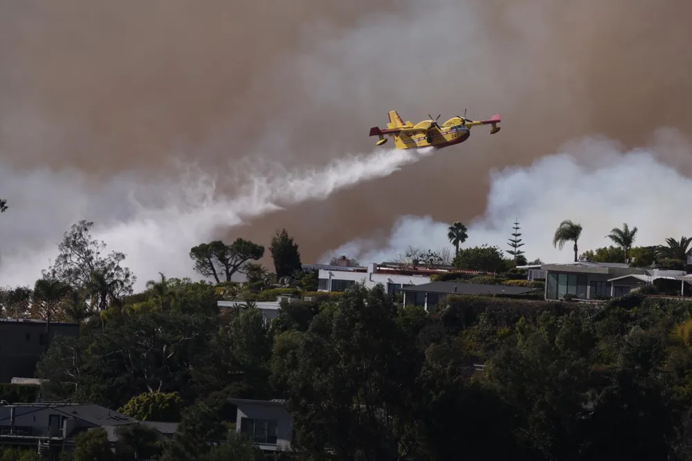 Pacific Palisades Fire Forces Evacuations and Road Closures Amid High Winds