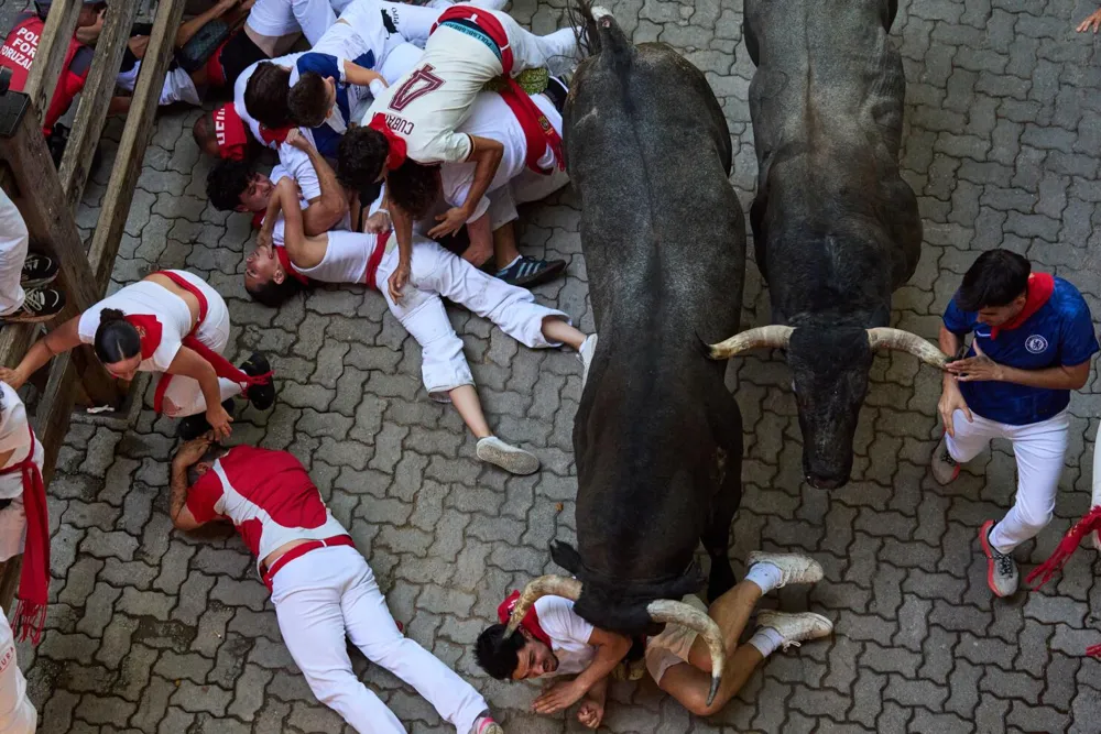 Runner gored in face during chaotic bull run at San Fermin festival