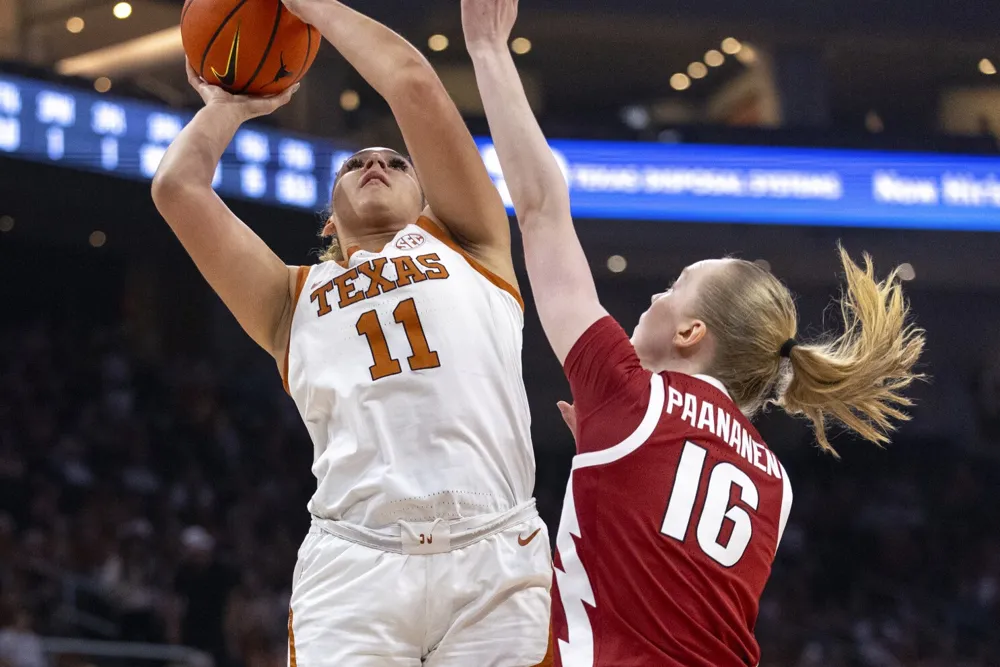 Texas Dominates Arkansas 90-56 with Moore's Double-Double Performance