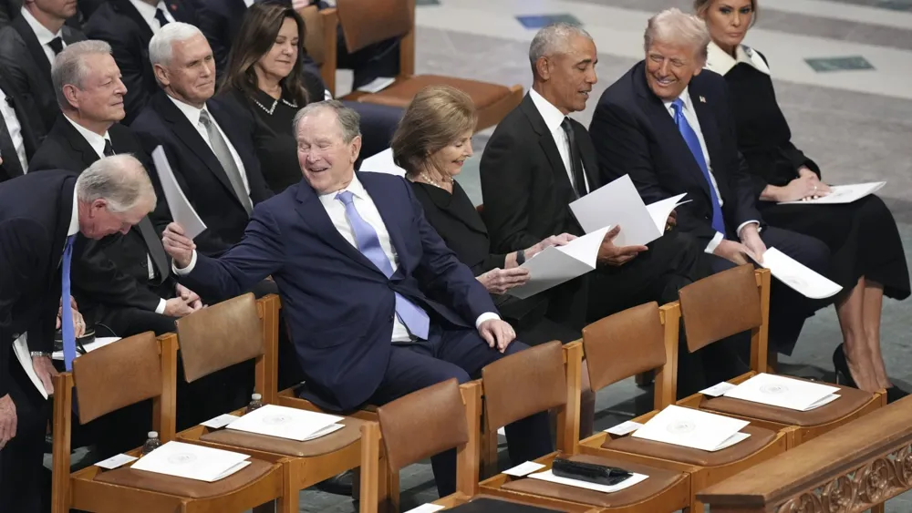 Trump Makes Obama Laugh at Carter Funeral, Video Goes Viral